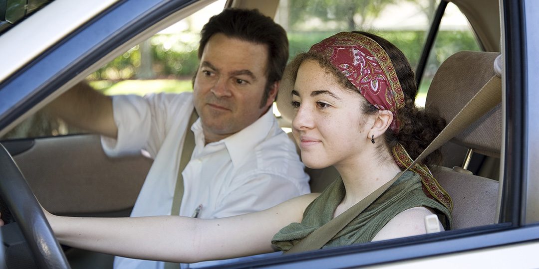 A teen taking a driving test.